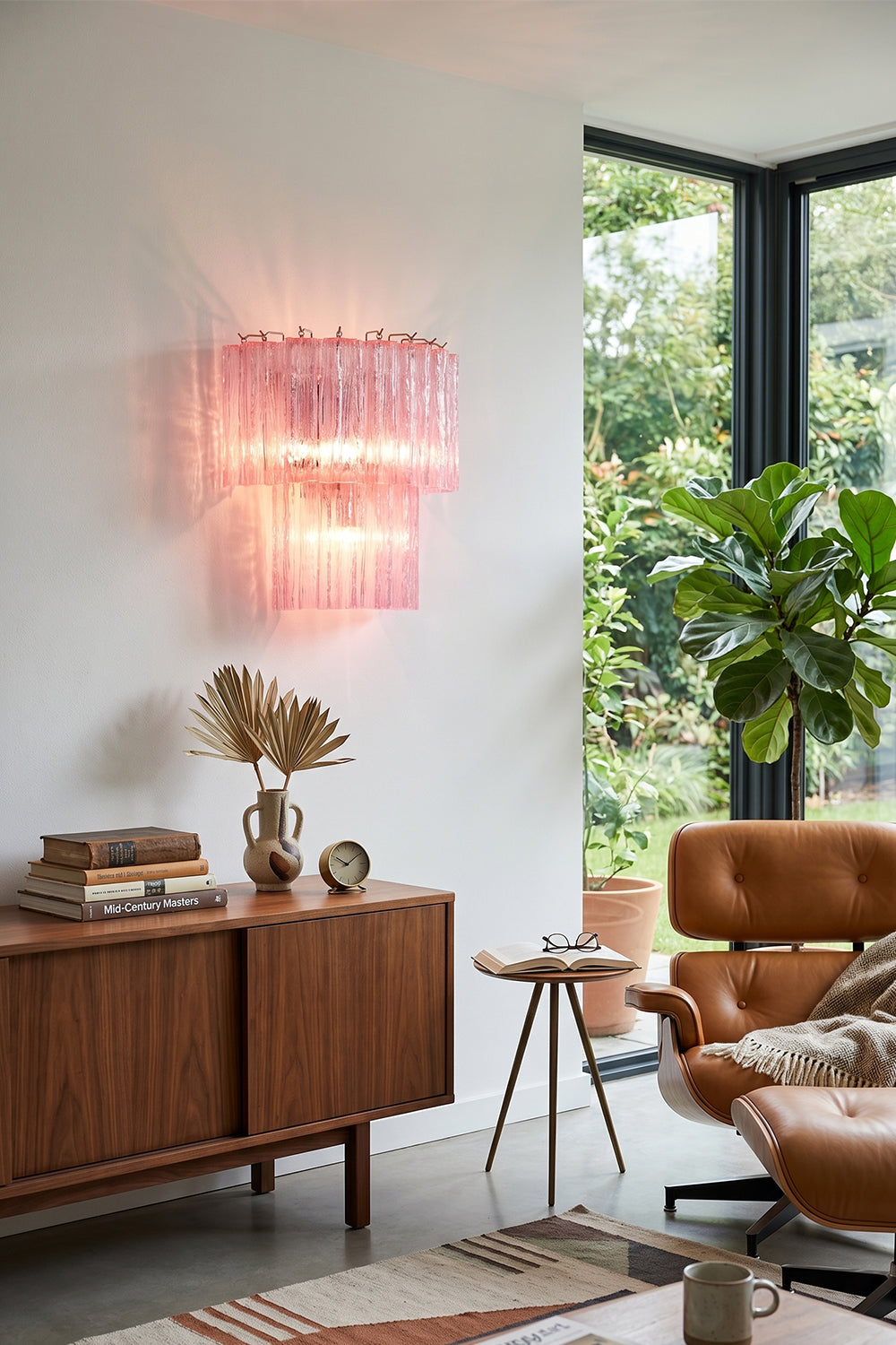 Cascading Prism Pink Glass Wall Light | Glass, Metal | Mounted above a mid-century wooden sideboard in a bright living room | vexa lamps Cascading Prism