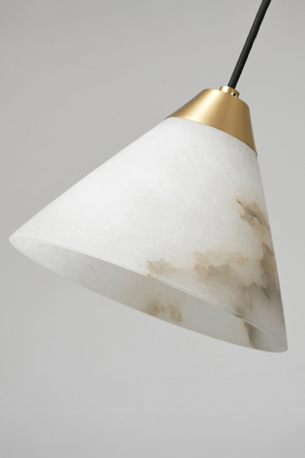 Caspian Conical Alabaster Pendant Light | Natural Alabaster and Brass | Macro texture close-up showcasing the unlit white stone shade and the golden metal top connection | vexa lamps