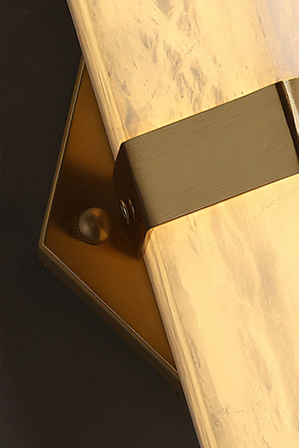 Close-up of the Cassian Faceted Alabaster Wall Sconce showing the brass-toned bracket and natural alabaster details.