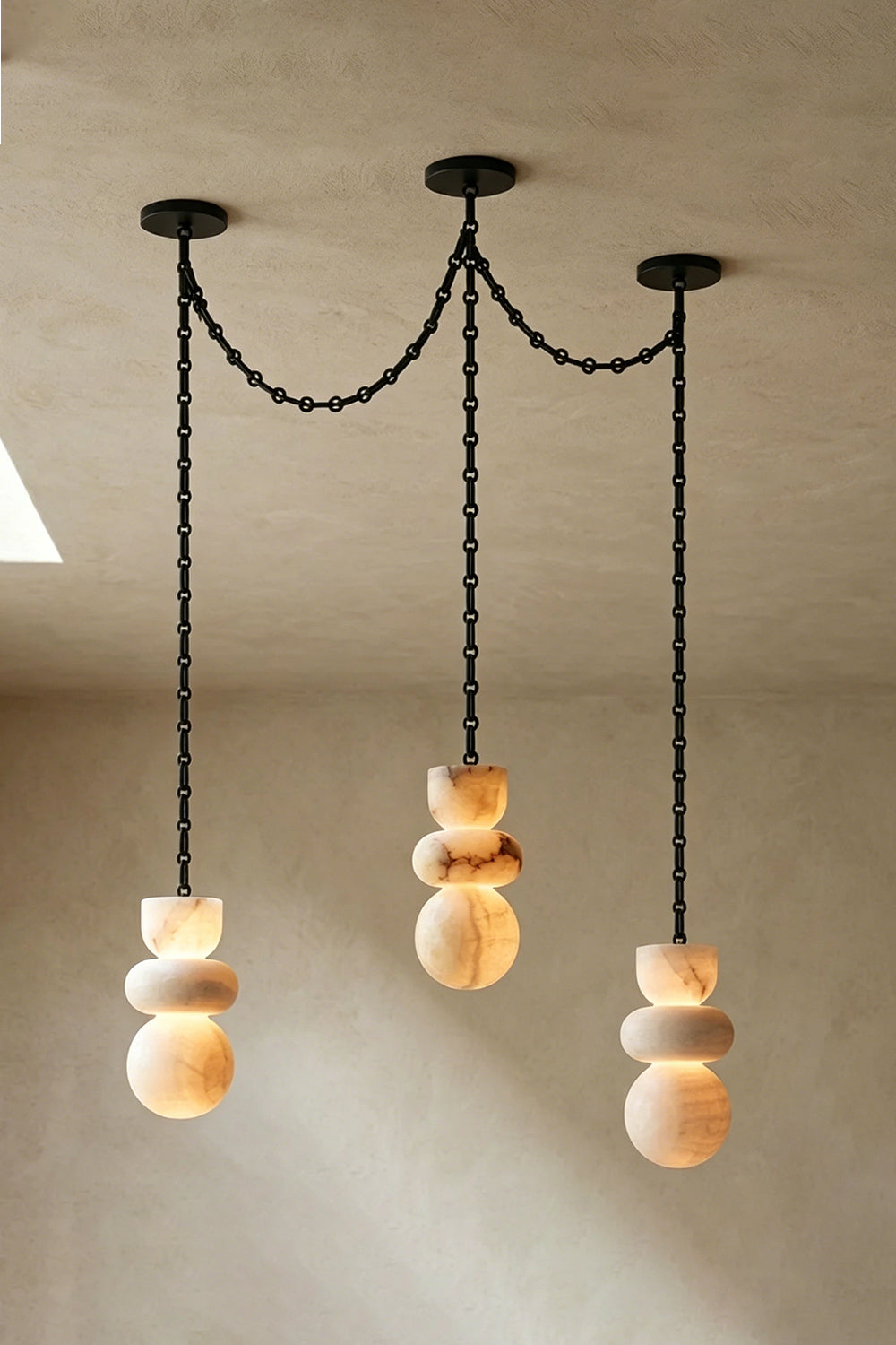 Celestial Alabaster Chandelier | Alabaster, Metal | Three-light swag configuration with organic stone forms | vexa lamps