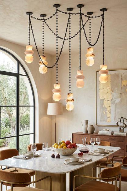 Celestial Alabaster Chandelier | Alabaster, Metal | Lit alabaster shades in a warm modern dining area | vexa lamps