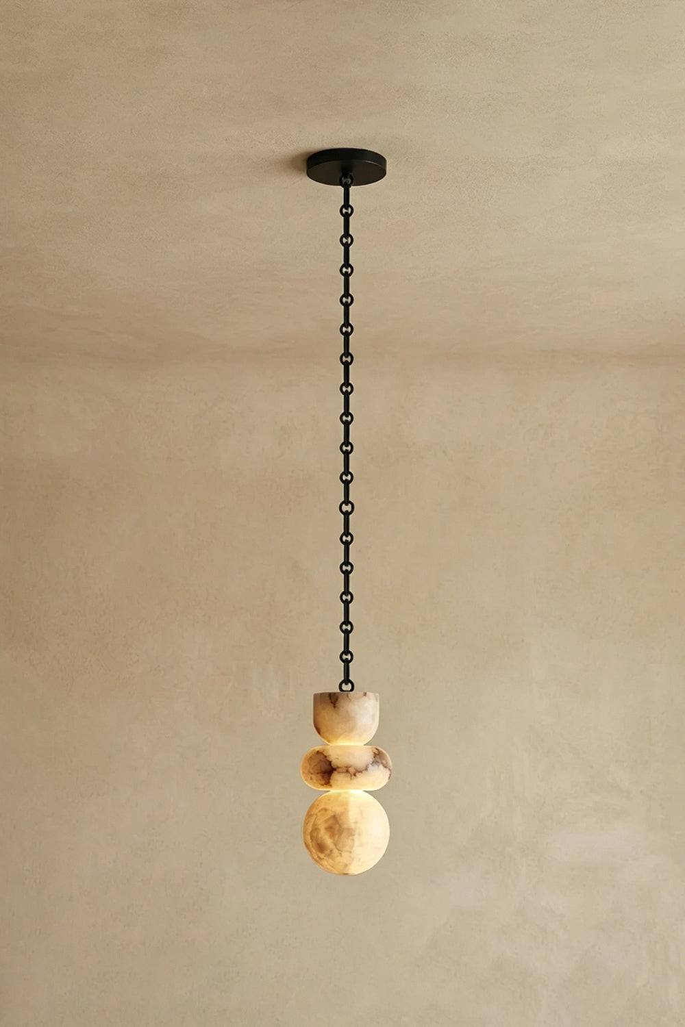 Single Alabaster Pendant | Alabaster, Metal | Straight vertical hanging against neutral wall | vexa lamps