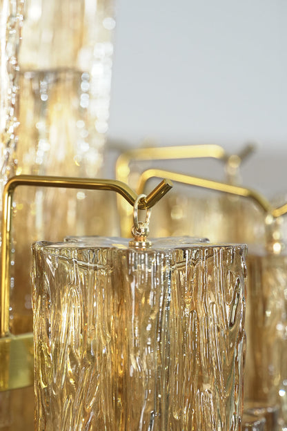 Close-up of the Celestial Glass Cascade Chandelier highlighting fluted glass tubes and gold accents.