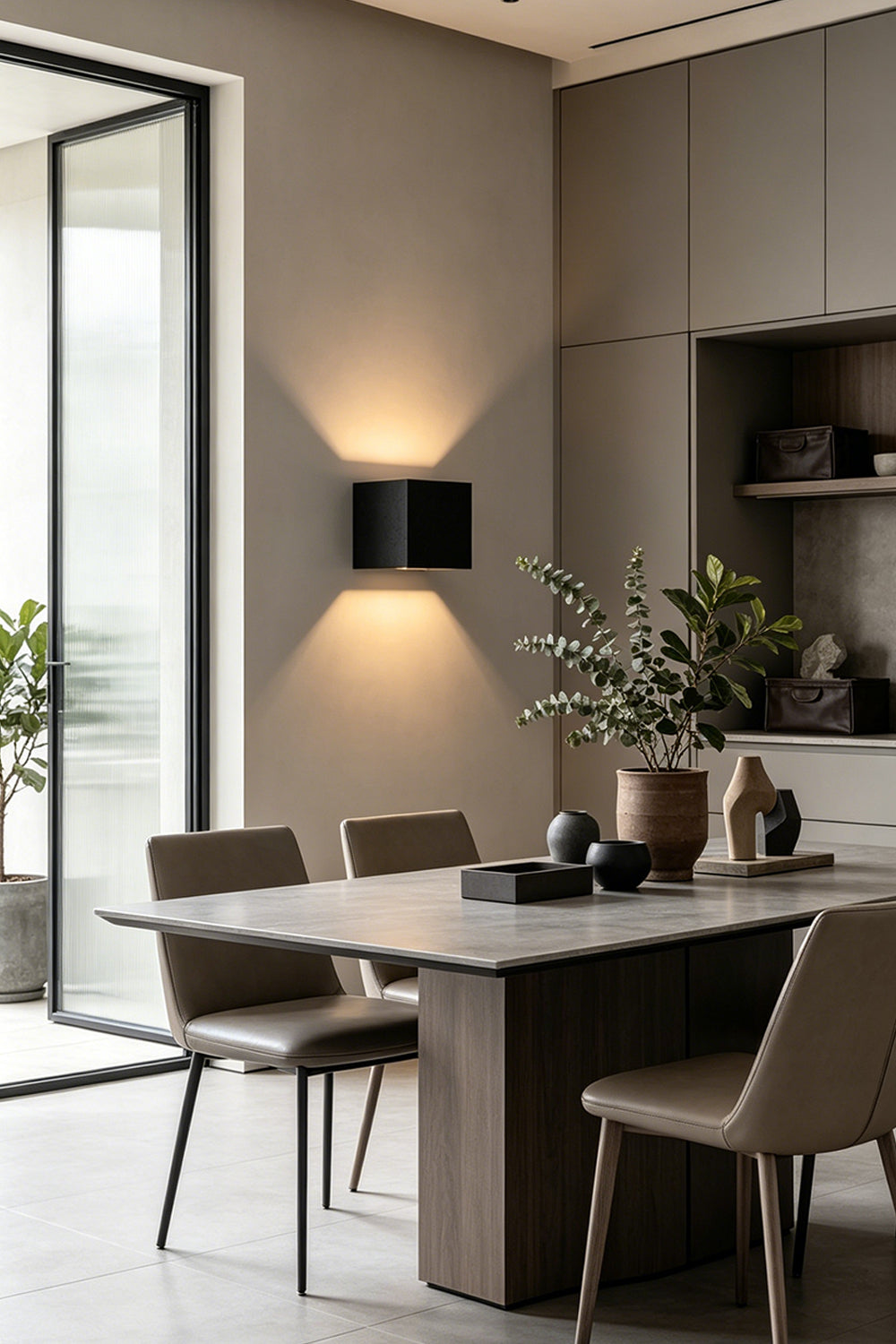 Celestial Tectonic Black Travertine Wall Lamp | Black Travertine | Dining room installation with warm up-and-down glow | vexa lamps