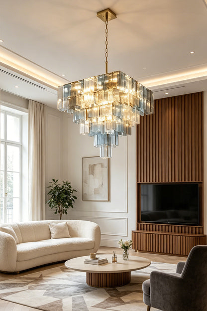 Clarissa Tiered Square Glass Chandelier | Living Room Decor | Positioned beautifully above a round coffee table in a spacious luxury living room with a plush cream sofa and wood slat wall | vexa lamps