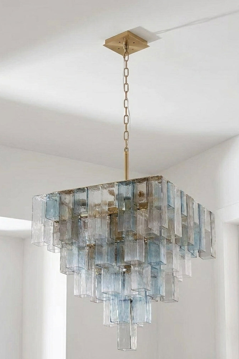 Clarissa Tiered Square Glass Chandelier | Studio Hanging View | Another illuminated studio shot of the multi-tiered square crystal-like pendant lamp fixture against a light backdrop | vexa lamps