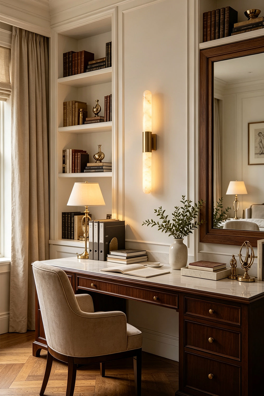 Corin Linear Alabaster Wall Sconce illuminating a stylish desk in a cozy home office setting.