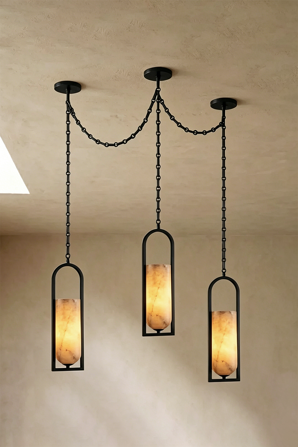 Cressida Alabaster Melange Chain Chandelier hanging from the ceiling in an upscale modern interior.