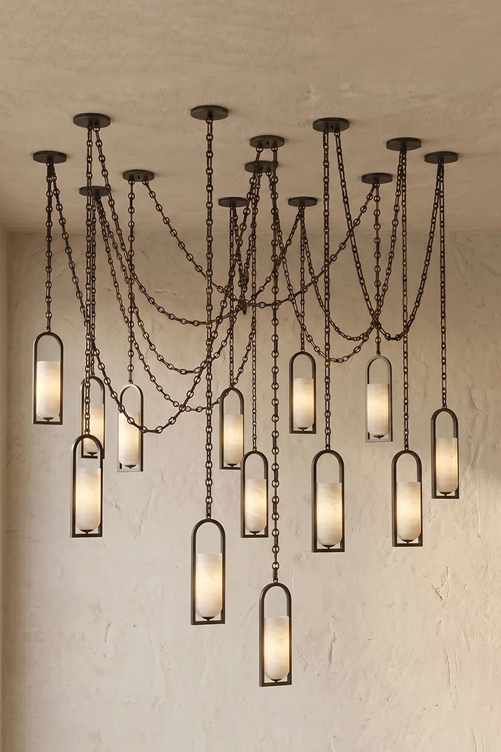 Cressida Alabaster Melange Chain Chandelier hanging from the ceiling in an upscale modern interior.