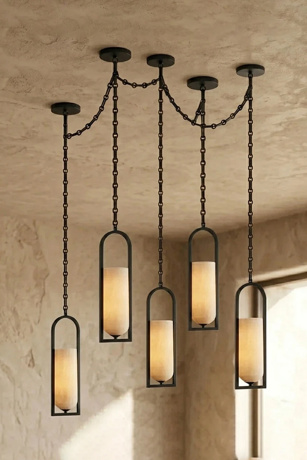 Cressida Alabaster Melange Chain Chandelier hanging from the ceiling in an upscale modern interior.