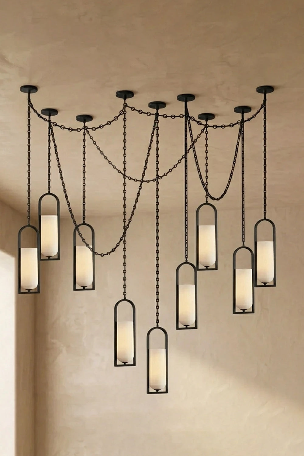 Cressida Alabaster Melange Chain Chandelier hanging from the ceiling in an upscale modern interior.