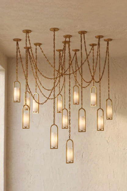 Cressida Alabaster Melange Chain Chandelier hanging from the Cressida Alabaster Melange Chain Chandelier hanging from the ceiling in an upscale modern interior.ceiling in an upscale modern interior.