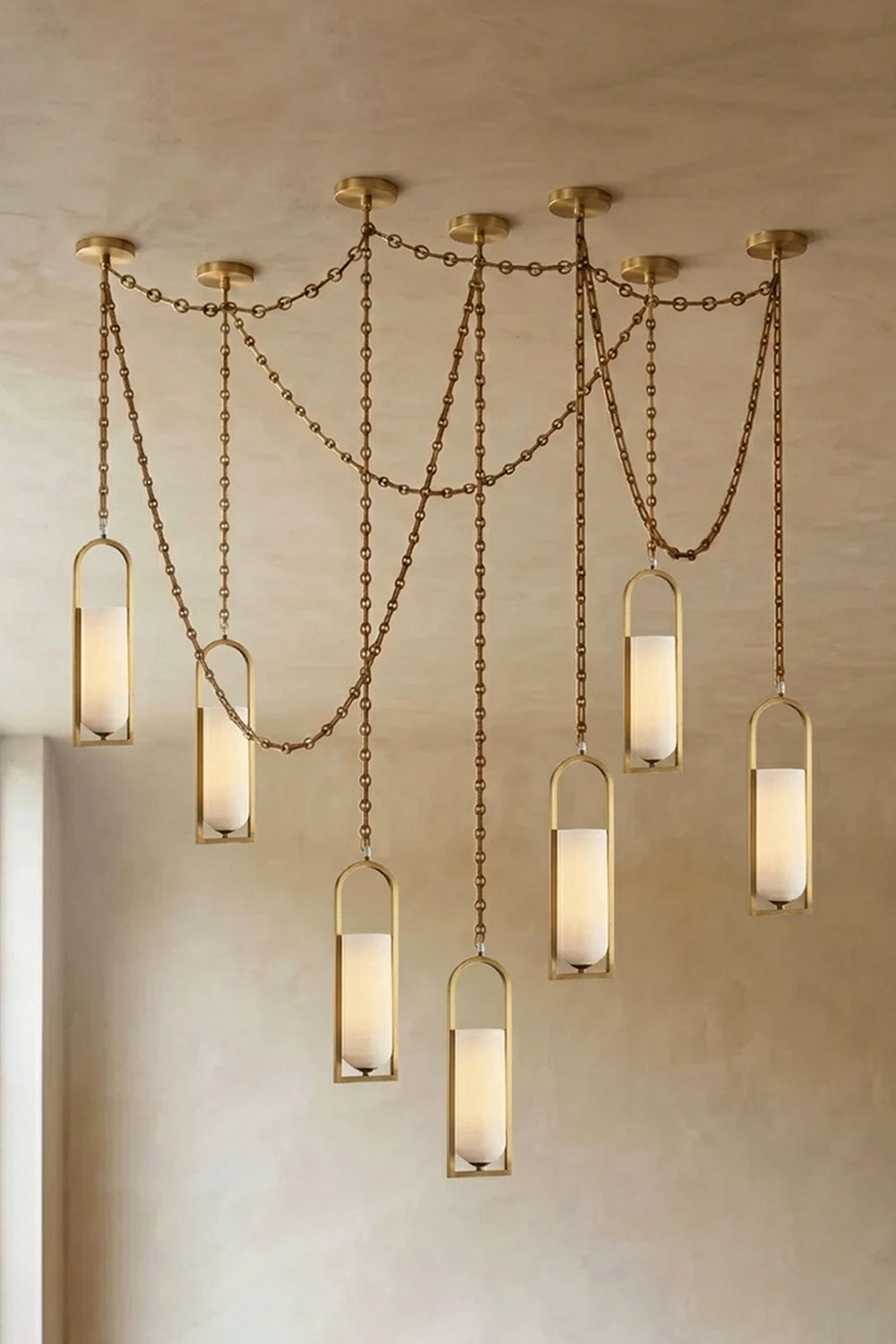 Cressida Alabaster Melange Chain Chandelier hanging from the ceiling in an upscale modern interior.