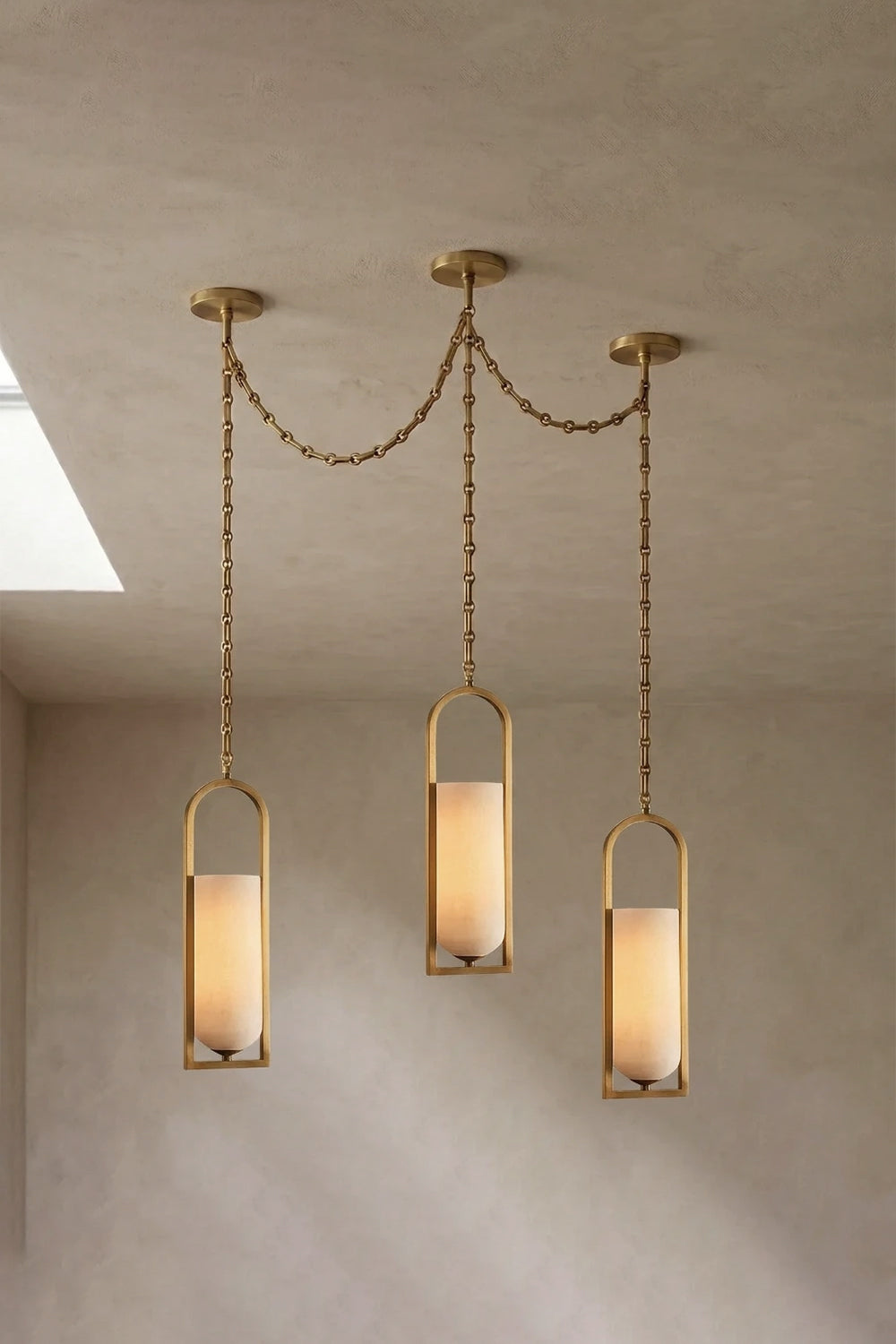 Cressida Alabaster Melange Chain Chandelier hanging from the ceiling in an upscale modern interior.