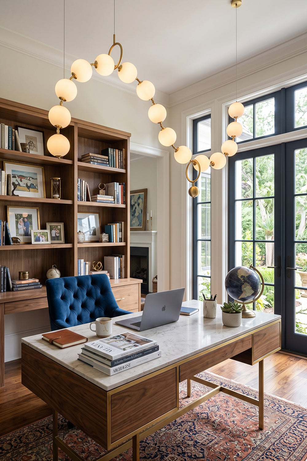Delphine Pearl Strand Chandelier illuminating a stylish home office with modern decor and a cozy atmosphere.