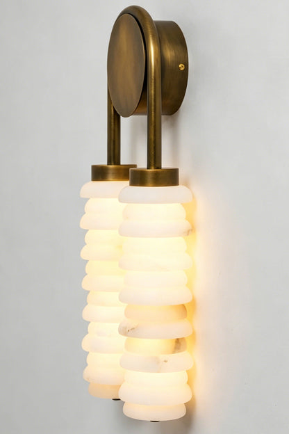 Dual Strata Alabaster Wall Lamp | Metal, Alabaster | Lit perspective detail shot against a neutral grey wall, showing stone texture | vexa lamps