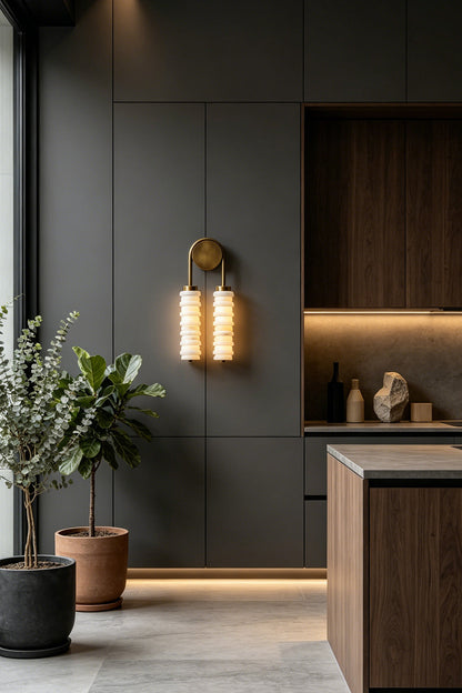Dual Strata Alabaster Wall Lamp | Metal, Alabaster | Lit lamp providing accent light in a modern kitchen with textured wood cabinetry and island | vexa lamps