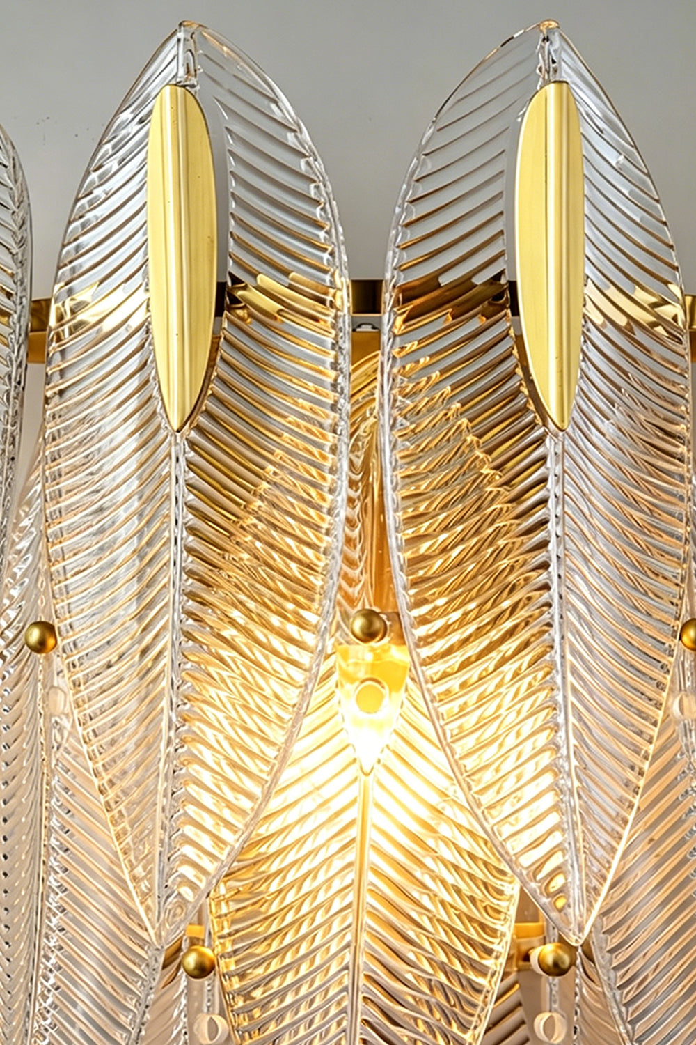 Elowen Cascading Glass Wall Lamp | Glass, Metal | Macro close-up view highlighting the glowing ribbed texture and feathery edges of the lit clear glass panels | Detail shot | vexa lamps