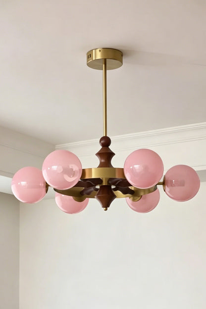 Lit pink glass globe version of the Elysian Circlet Chandelier | Metal, Glass, Wood | Perspective view showing the circlet design | vexa lamps