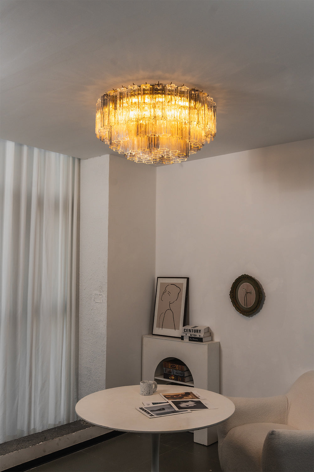 Elysian Tiered Fluted Ceiling Light | Glass, Metal | Installed in a minimalist interior transition space, throwing soft light over a round white lounge table | vexa lamps