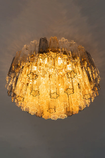 Elysian Tiered Fluted Ceiling Light | Glass, Metal | Low-angle profile shot of the fully illuminated tiered flush mount fixture radiating a rich amber light halo against a dark ceiling | vexa lamps