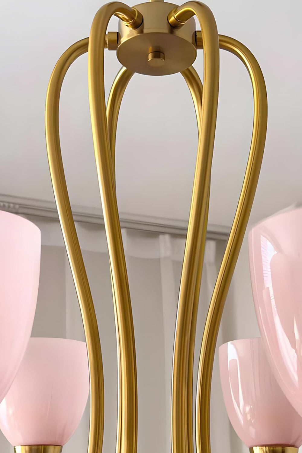 Close-up detail of the intricate brass-finished metal frame of a Ethereal Floret Chandelier | Metal | Functional detail view of the ceiling mount and arms | vexa lamps