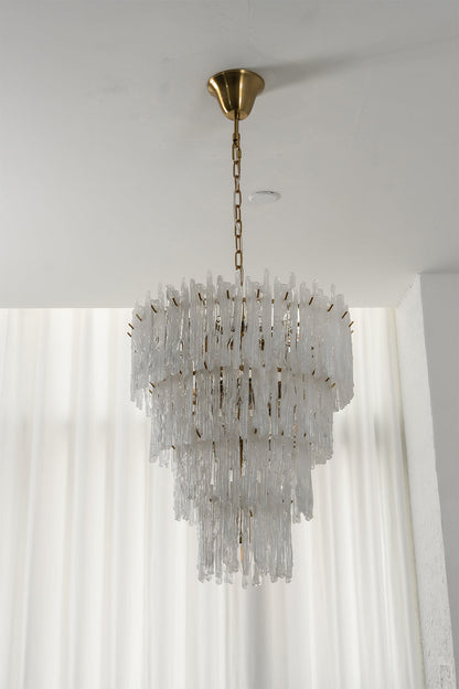 Ethereal Icicle Waterfall Chandelier | Glass, Metal | Unlit view of the tiered glass chandelier showcasing its crystalline elegance in front of sheer white blinds | vexa lamps