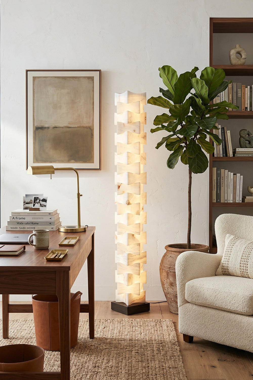 Ethereal Monolith Alabaster Floor Lamp | Lit in rustic modern workspace corner | Desk with chair and Fiddle Leaf Fig | Near a white couch with abstract art | vexa lamps