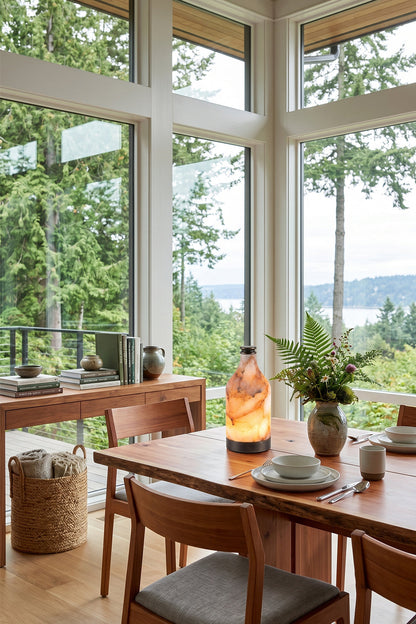 Evander Alabaster Bottle Table Lamp | Alabaster, Metal | Serving as an artistic stone centerpiece on a long wooden dining table in an open-concept dining space with panoramic nature views | vexa lamps