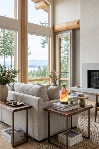 Evander Alabaster Bottle Table Lamp | Alabaster, Metal | Positioned on a wooden end table behind a cream sectional sofa in a modern mountain lodge living room with expansive views | vexa lamps