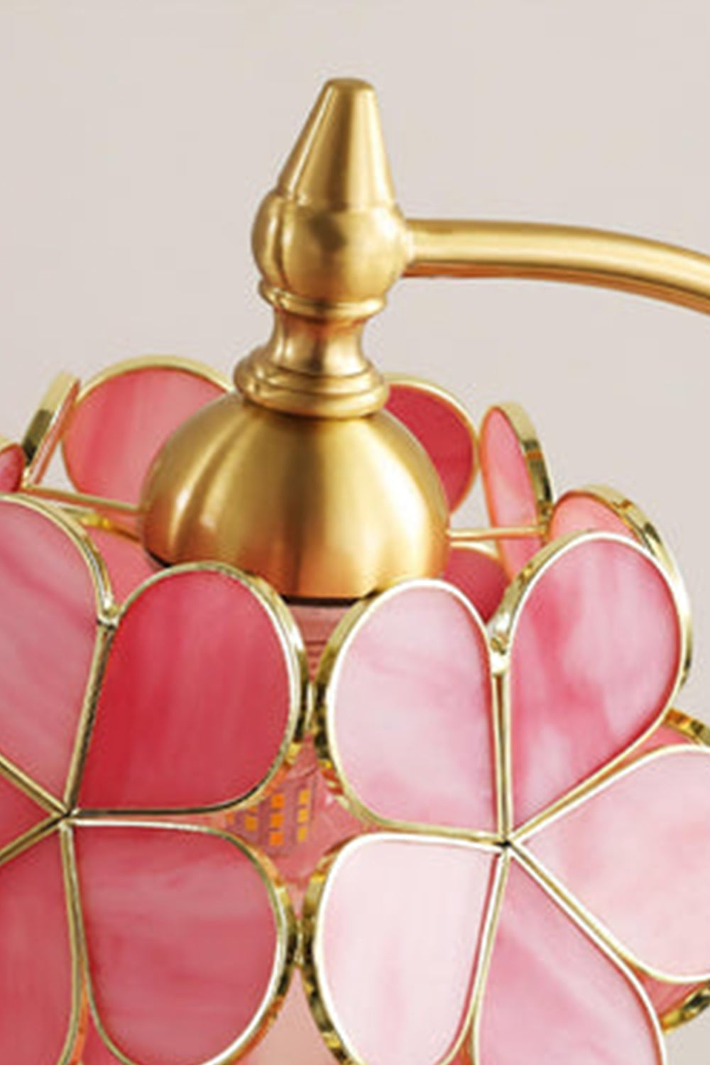 Evanthe Blossom Stained Glass Table Lamp | Stained Glass, Metal | Close-up focus on the polished gold brass top hardware cap and screw finial connecting the stem to the floral glass shade | Detail shot | vexa lamps
