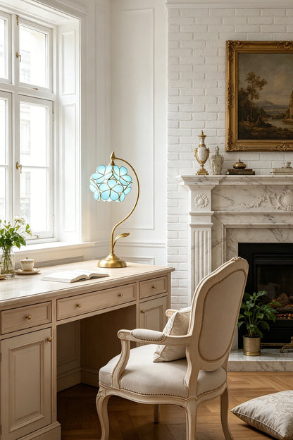 Evanthe Blossom Stained Glass Table Lamp | Stained Glass, Metal | Positioned as a charming desk light on a vintage white wooden writing table paired with a classical French upholstered armchair | vexa lamps