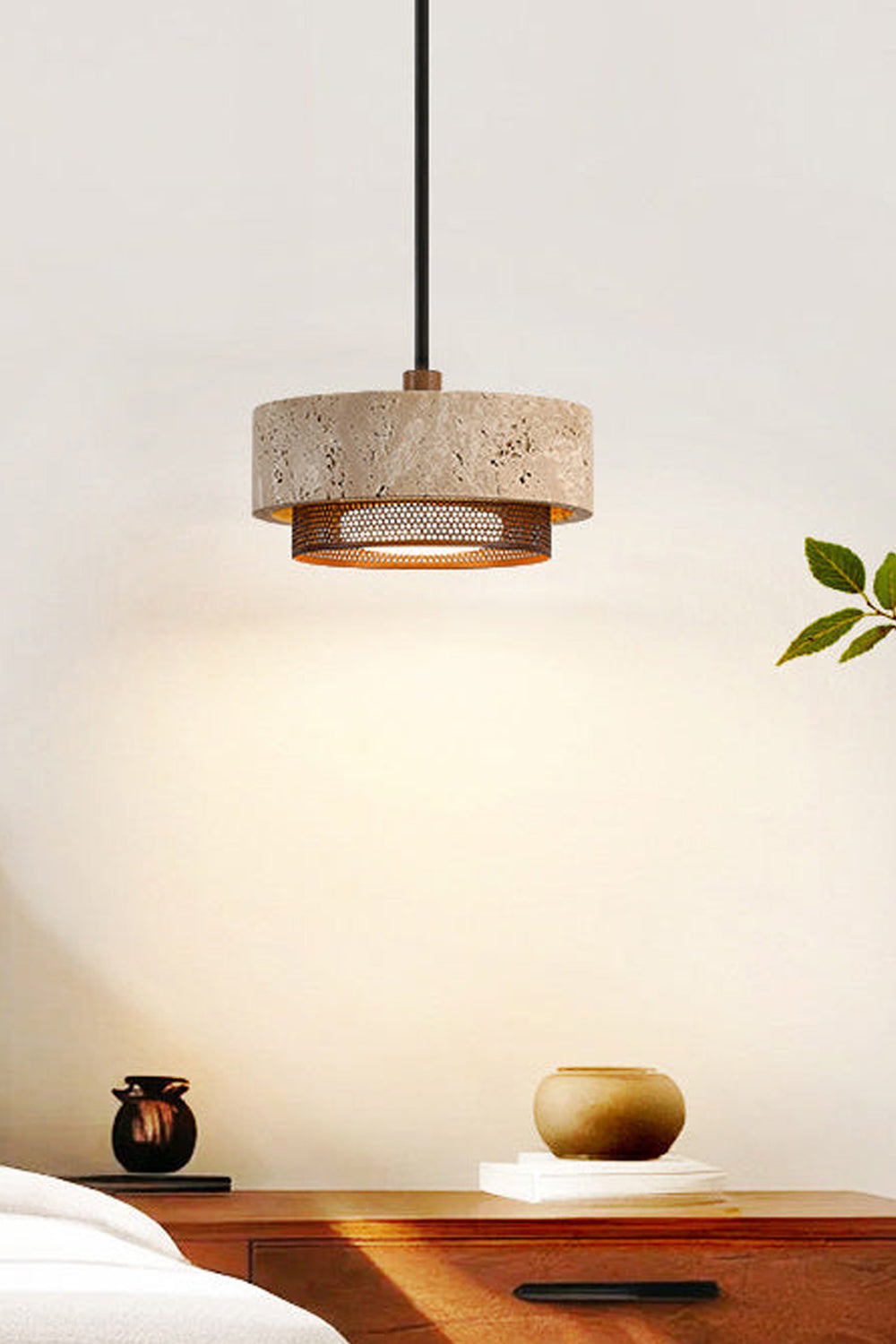 Evora Travertine Pendant Light showcasing a cylindrical beige travertine stone design with a metal diffuser above a modern table.
