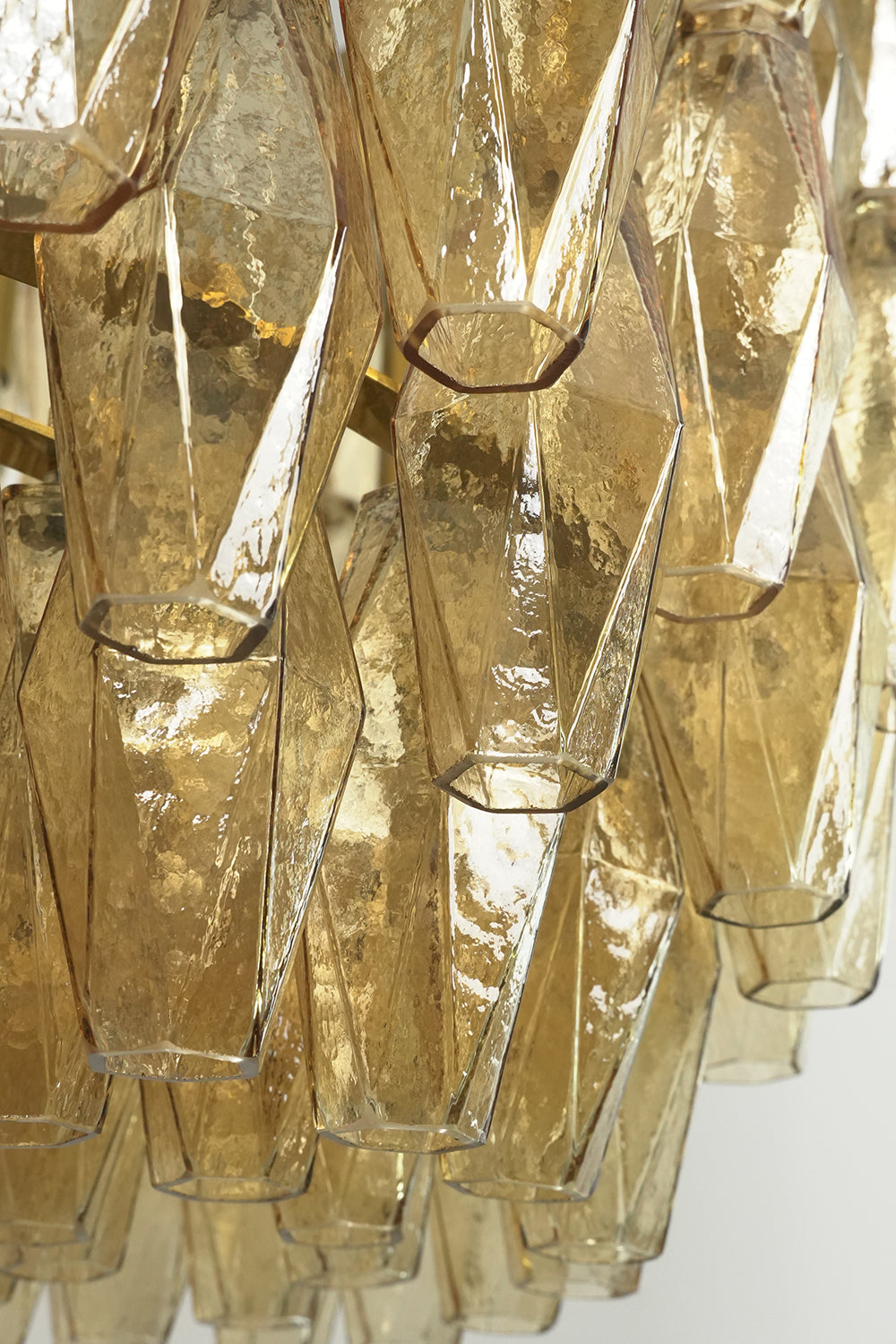 Close-up of unlit faceted amber glass prisms | Glass | Detailed view of the textured glass surface | vexa lamps