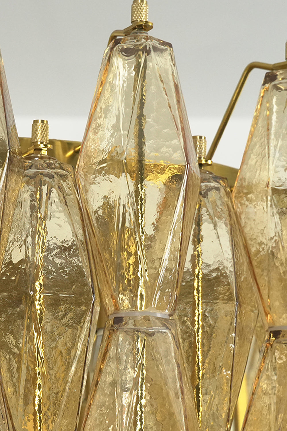 Detail shot of amber glass prism attachment | Metal, Glass | Close-up of the metal hook and textured glass | vexa lamps