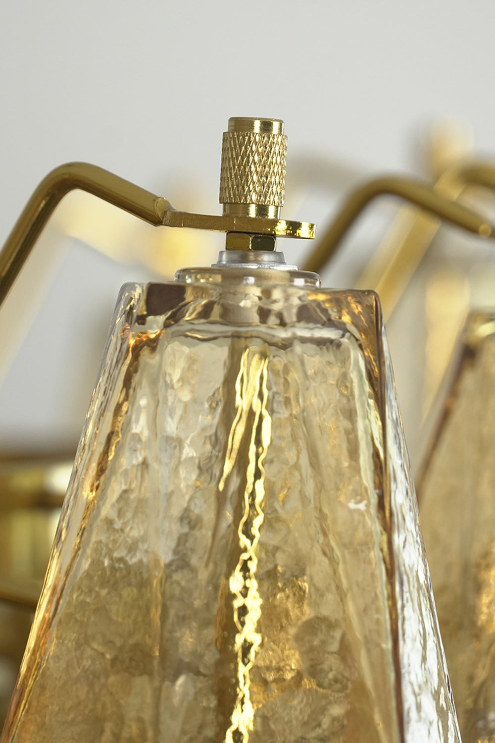 Close-up of glass prism screw connection | Metal, Glass | Macro shot of the faceted glass top and metal hardware | vexa lamps