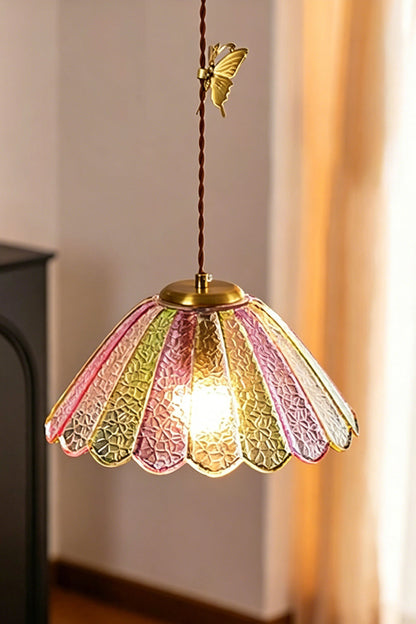 Faye Pastel Scalloped Glass Pendant Lamp | Glass, Metal | Close-up shot of the single illuminated pastel glass pendant throwing a warm golden light in a cozy corner | vexa lamps
