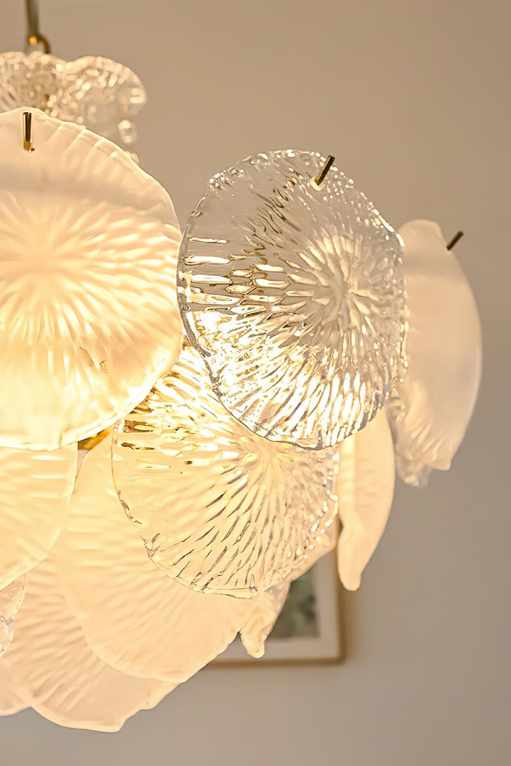 Close-up view of the Fiore Radiance Glass Disc Chandelier showcasing elegant glass discs with intricate textures.