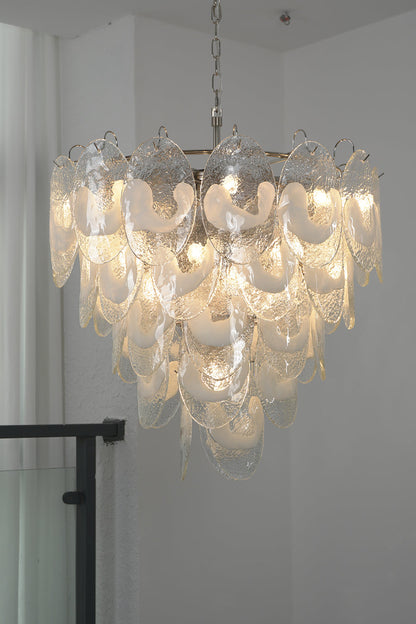 Lit glass leaf chandelier with tiered design | Metal, Glass | Installed in a corner near a staircase railing | vexa lamps