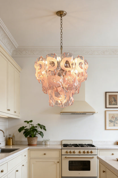 Modern pink glass chandelier | Metal, Glass | Installed in a white kitchen with beige stove | vexa lamps