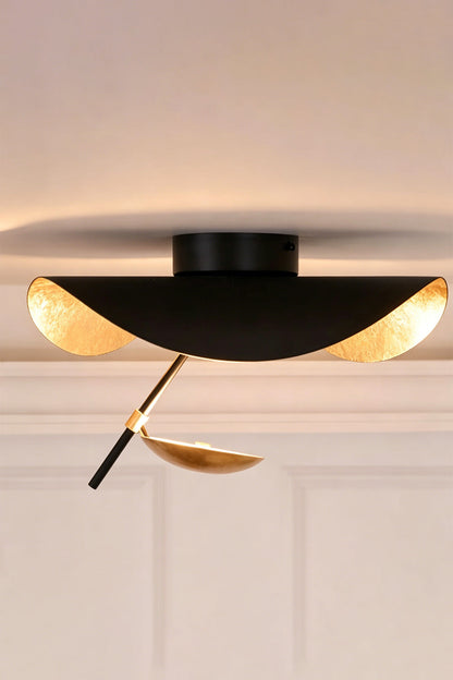 Gold-Tone Sculptural Ceiling Light with matte black exterior and crinkled gold finish, showcasing fluid geometry.