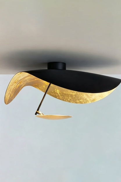 Gold-Tone Sculptural Ceiling Light showcasing a wave-like black and gold design, ideal for modern decor.