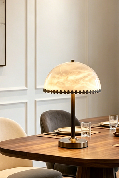 Helena Alabaster Trim Table Lamp | Cozy Dinner Lighting | Detailed view of the illuminated dome stone table lamp casting a warm yellow halo on a dark wood dining table | vexa lamps