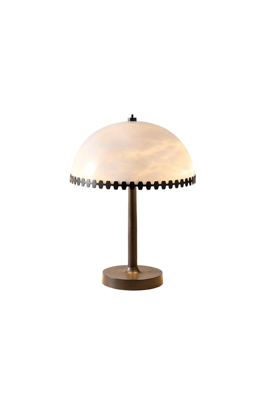 Helena Alabaster Trim Table Lamp | Alabaster, Bronze | Isolated lit product view of a modern dome-shaped table lamp featuring a translucent white alabaster stone shade with a notched dark bronze trim, slim stem, and round flat base | White background | vexa lamps