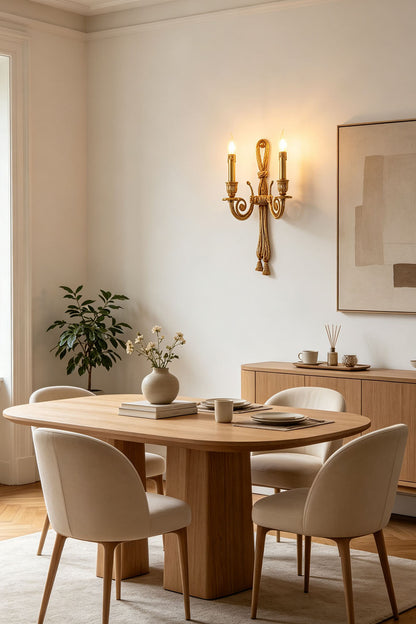 Honoria Rope and Tassel Brass Sconce | Brass and Metal | Glowing warmly on a wall next to a round dining table setup | vexa lamps