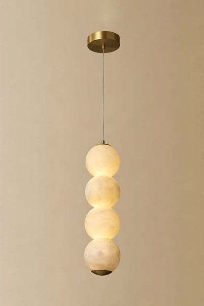 Imperial Epoch Alabaster Pendant Lamp | Metal, Alabaster | Full view of the four-sphere pendant variant against a beige background | vexa lamps