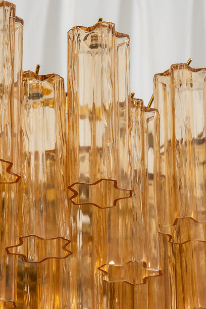 Close-up view of the Isadora amber glass chandelier showcasing clusters of amber-tinted glass prisms.