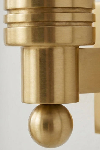 Isolde Alabaster Orb Wall Sconce | Natural Alabaster and Aged Brass | Detailed close-up macro shot of the ribbed brass cylinder holder and the small ball finial | vexa lamps