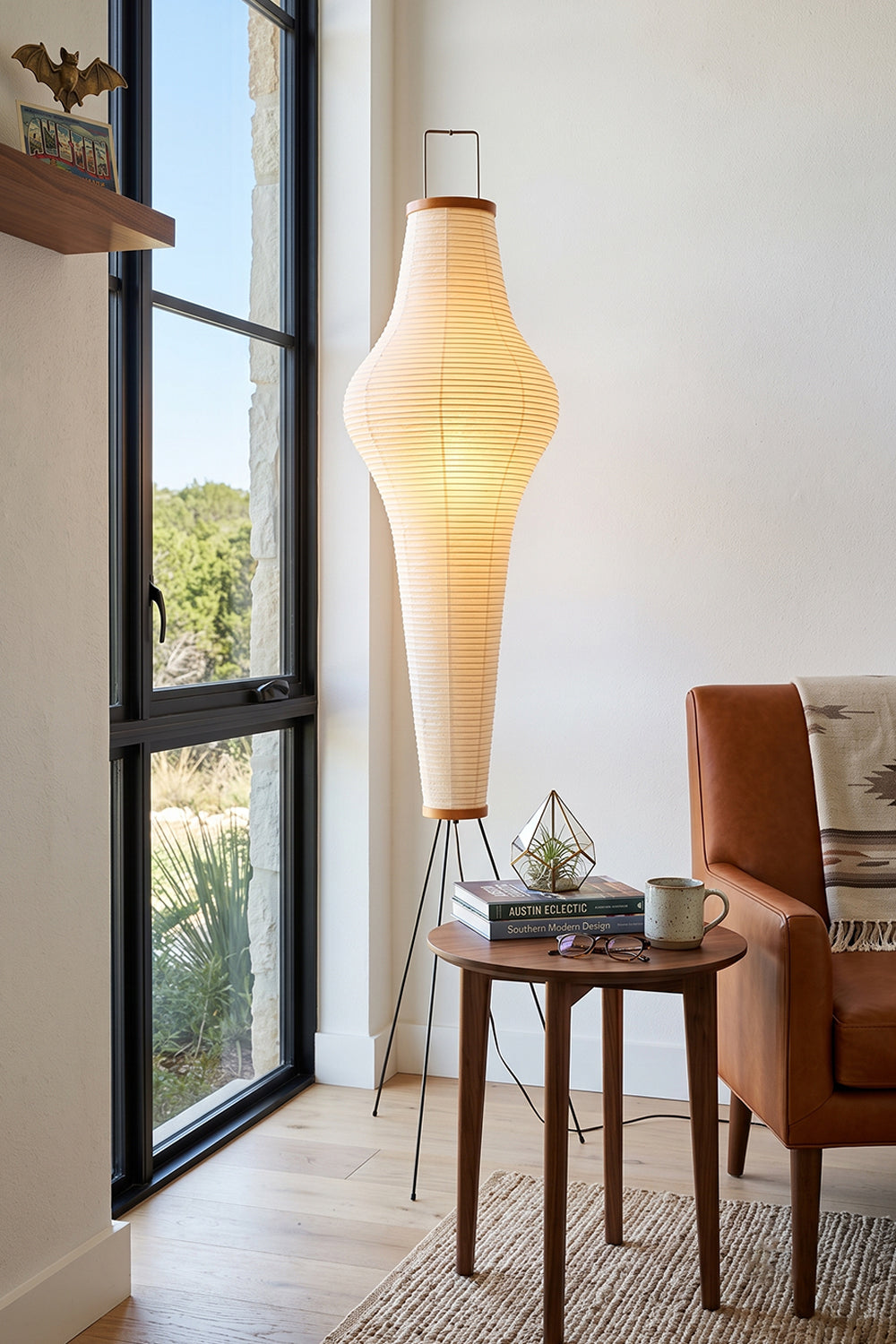 Isolde Ribbed Paper Column Floor Lamp illuminating a cozy living space with a warm glow.
