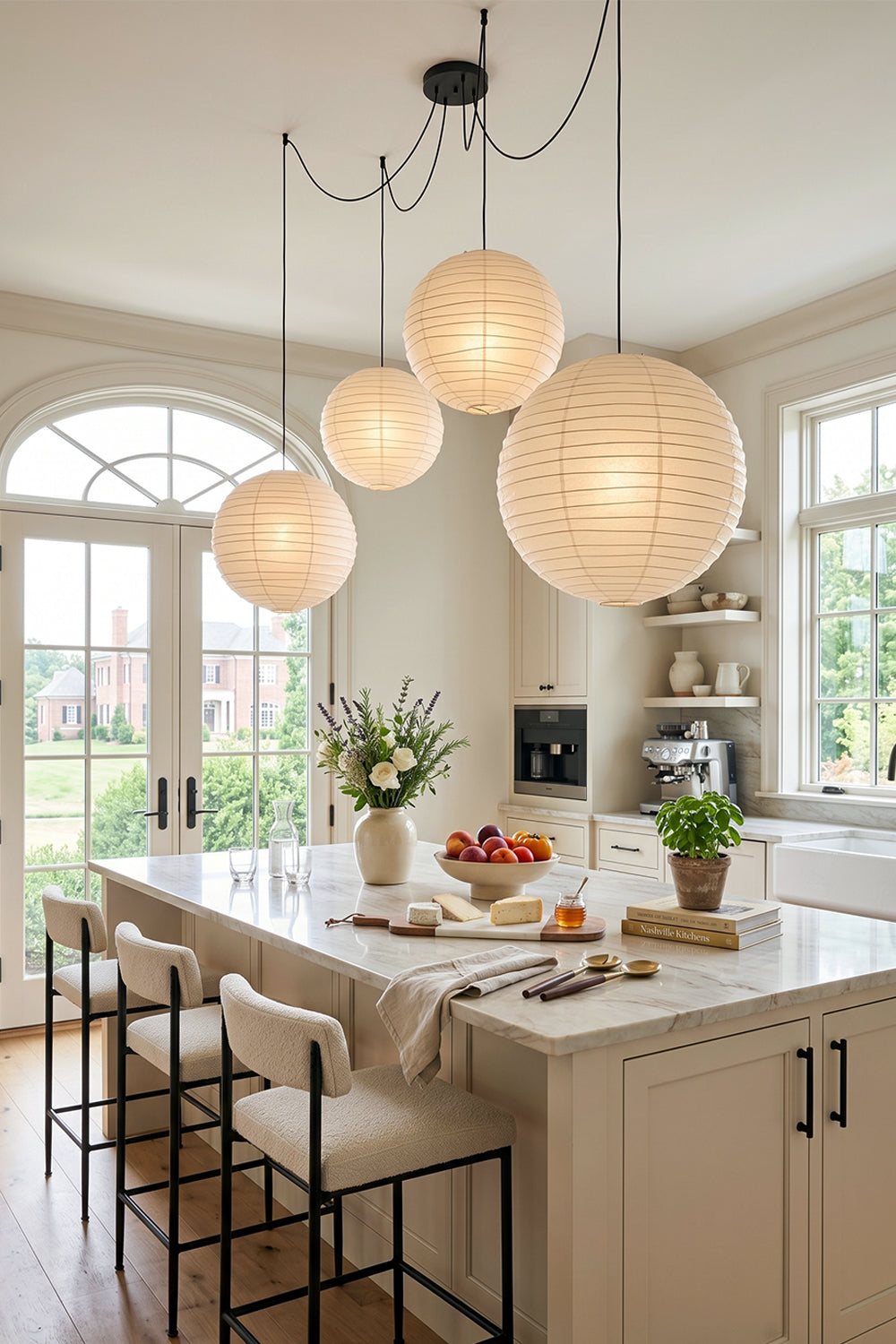 Komorebi Mulberry Paper Pendant Light | Paper, Bamboo | Clustered organic paper lanterns hanging above a pristine white kitchen island counter with black minimalist bar stools | vexa lamps